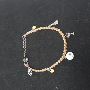 Bracelet with orange rope and charms